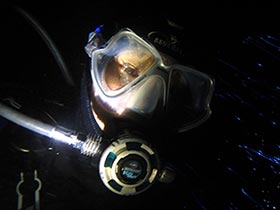 Night diver taking a selfy while diving in Phuket